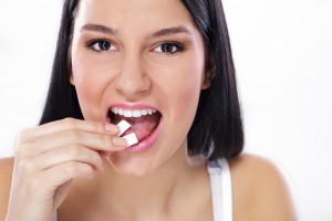 young girl refreshing breath with a mint gum