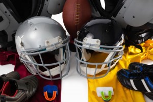 An assortment of helmets, jerseys and mouthguards for football. 